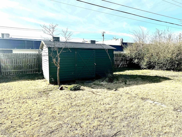 view of shed with a fenced backyard