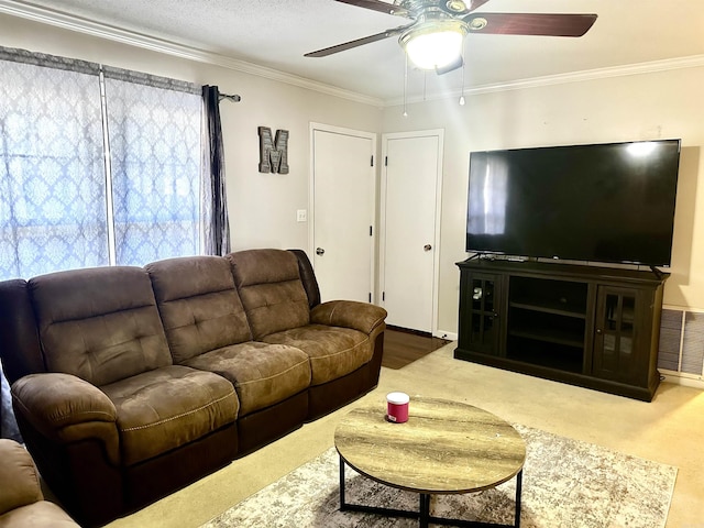 living area with visible vents, carpet floors, ceiling fan, and ornamental molding