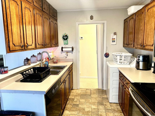 kitchen featuring stone finish floor, light countertops, black dishwasher, and a sink