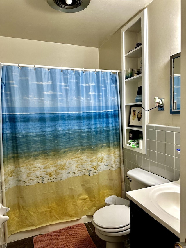 bathroom featuring curtained shower, toilet, tile walls, and vanity