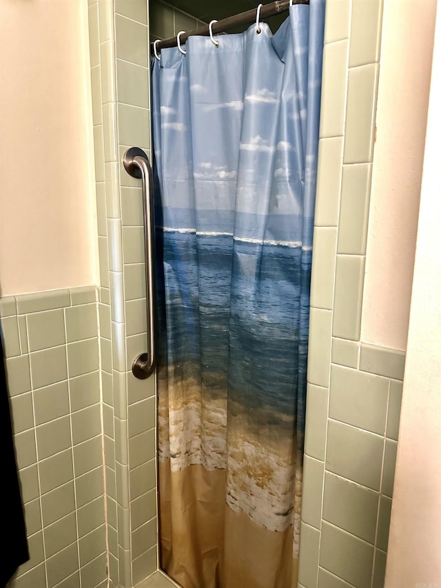 full bathroom with tile walls and tiled shower