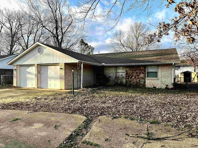 single story home with driveway, brick siding, an attached garage, and fence