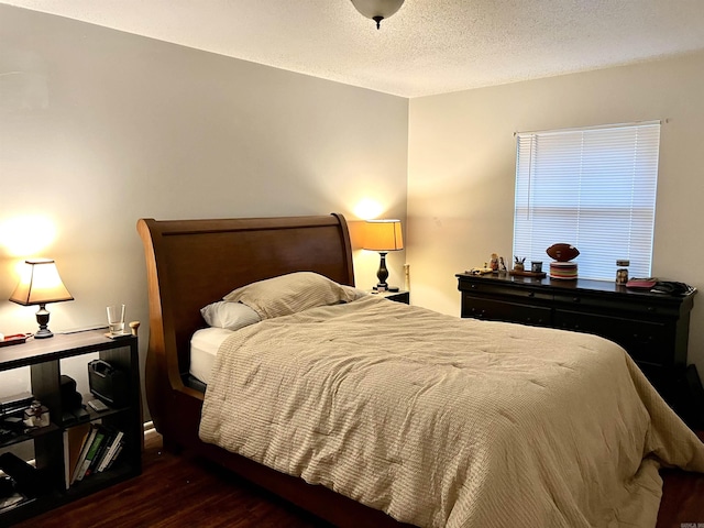 bedroom with wood finished floors and a textured ceiling