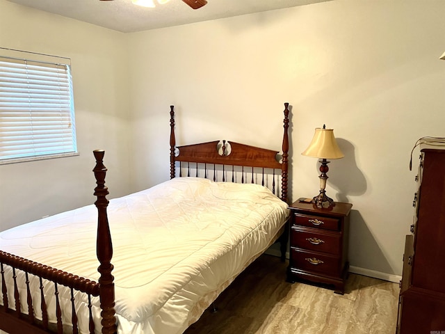 bedroom featuring baseboards, light wood-style flooring, and a ceiling fan