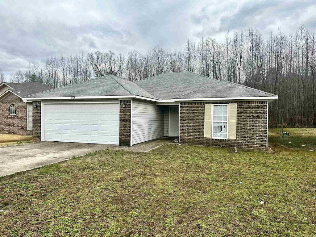 single story home with brick siding, concrete driveway, a front yard, and a garage