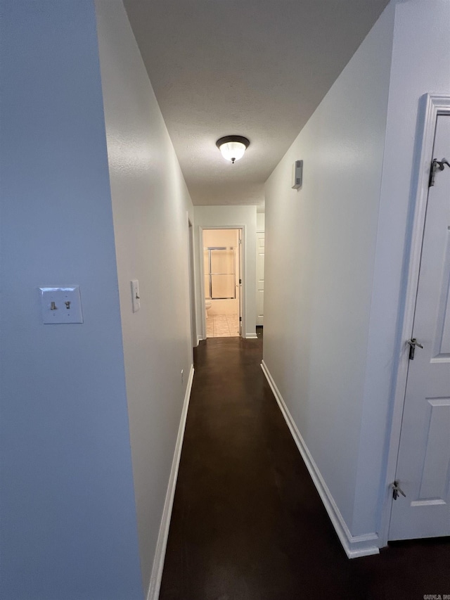 corridor featuring baseboards