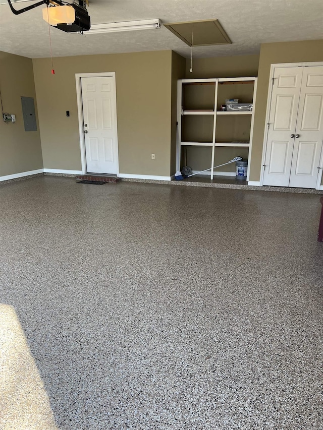 garage with electric panel, baseboards, and a garage door opener