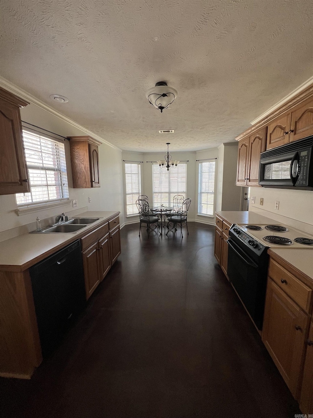 kitchen with black appliances, crown molding, light countertops, and a wealth of natural light