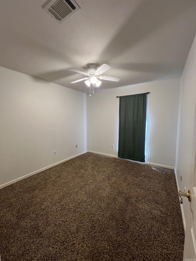 carpeted spare room featuring visible vents, a textured ceiling, a ceiling fan, and baseboards