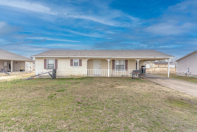 single story home featuring an attached carport, covered porch, a front yard, and driveway