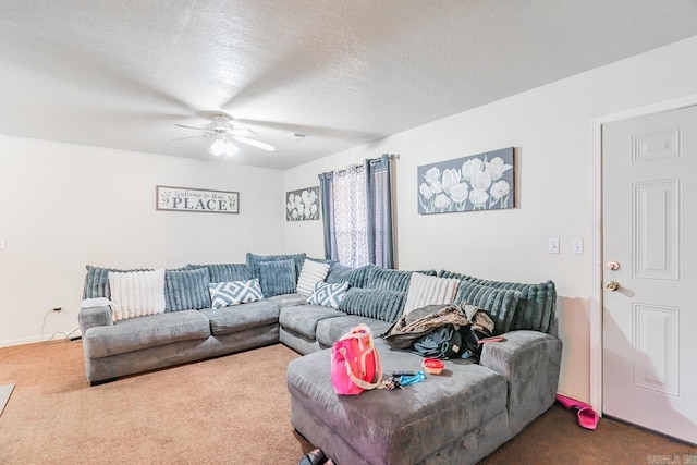 carpeted living area with a textured ceiling and ceiling fan