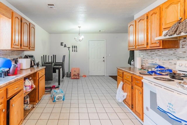 kitchen featuring visible vents, light countertops, light tile patterned floors, white electric range oven, and a notable chandelier