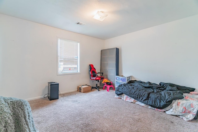 carpeted bedroom with baseboards and visible vents