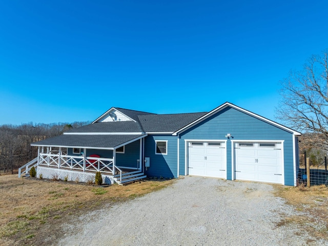 view of front of property featuring a porch, driveway, and a shingled roof