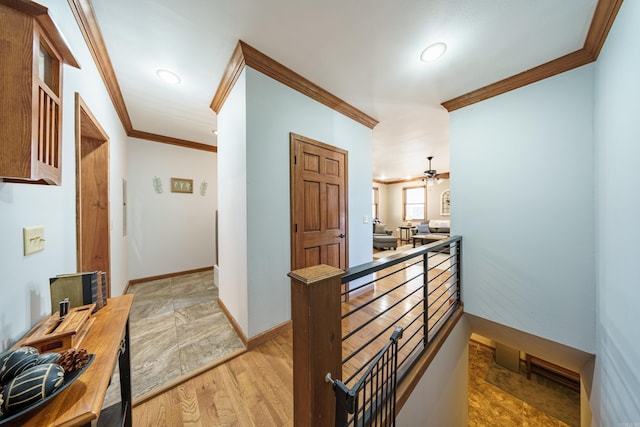 hallway with recessed lighting, light wood-type flooring, baseboards, and ornamental molding