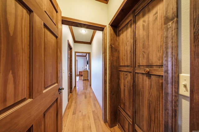 hall featuring ornamental molding and light wood finished floors