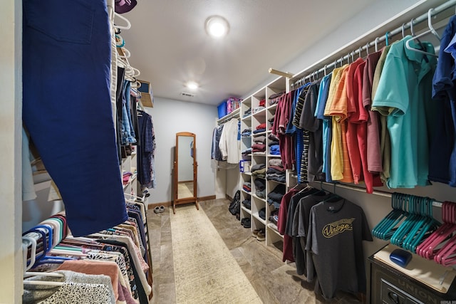 spacious closet featuring visible vents