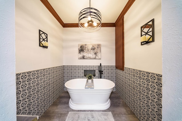 bathroom featuring a soaking tub, tile walls, wainscoting, and crown molding