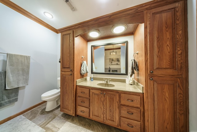 bathroom with visible vents, crown molding, baseboards, toilet, and vanity