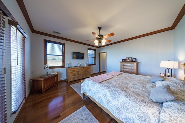 bedroom featuring visible vents, crown molding, baseboards, ceiling fan, and dark wood-style flooring