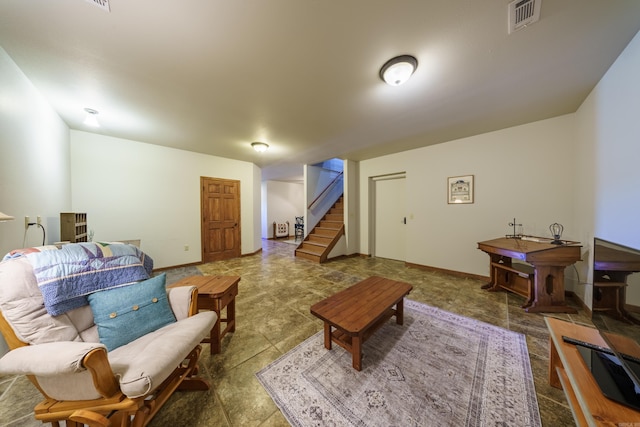 living area with visible vents, stairs, and baseboards