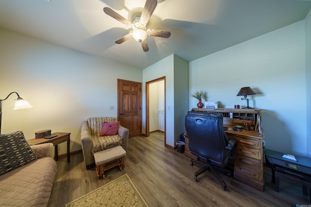 office featuring a ceiling fan, baseboards, and wood finished floors