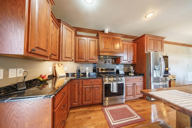 kitchen featuring light wood-style floors, brown cabinets, and appliances with stainless steel finishes