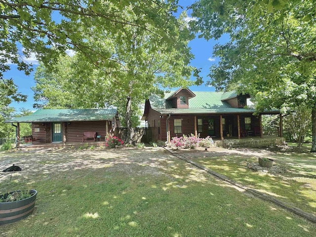 exterior space with covered porch and a front lawn