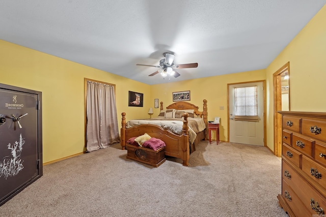 carpeted bedroom featuring baseboards and ceiling fan