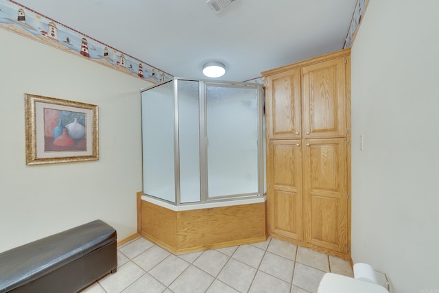 bathroom with tile patterned floors, visible vents, a stall shower, and toilet