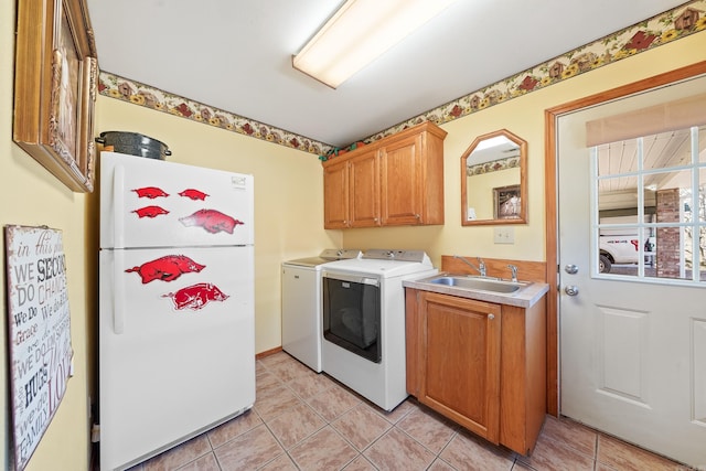 laundry room with laundry area, light tile patterned floors, independent washer and dryer, and a sink