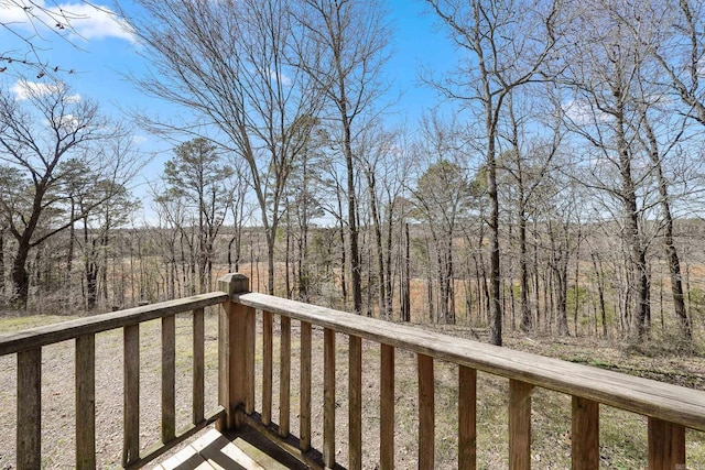 wooden terrace with a wooded view