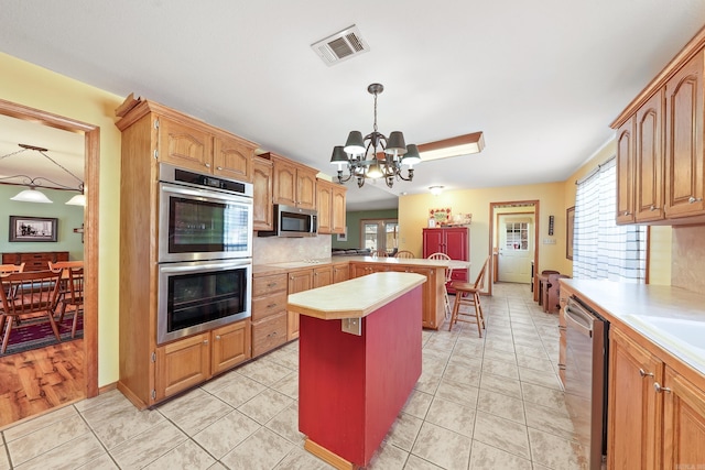 kitchen with light countertops, a wealth of natural light, visible vents, and appliances with stainless steel finishes