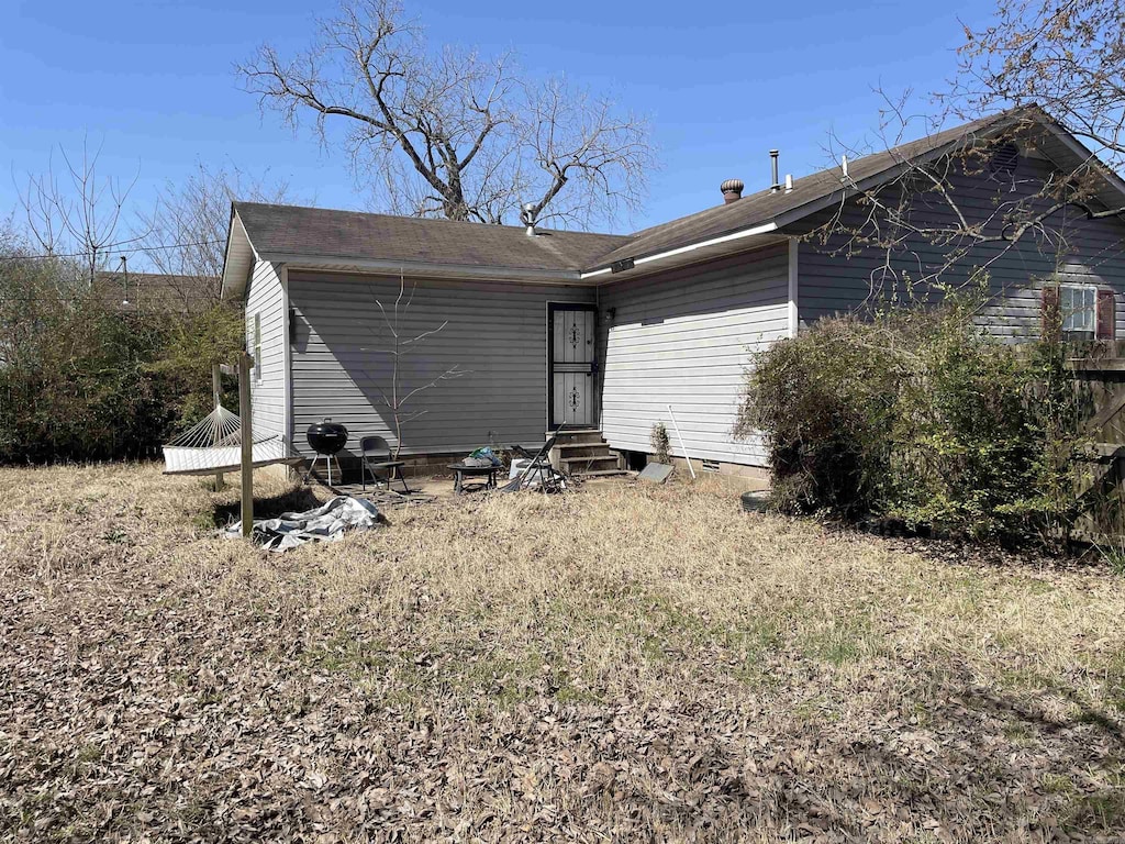 rear view of house featuring crawl space and entry steps