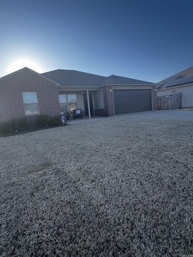 ranch-style house with a garage and brick siding