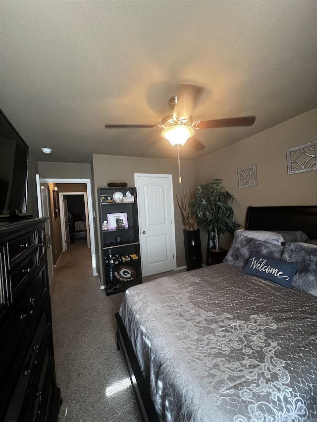 bedroom with a textured ceiling, ceiling fan, and carpet floors