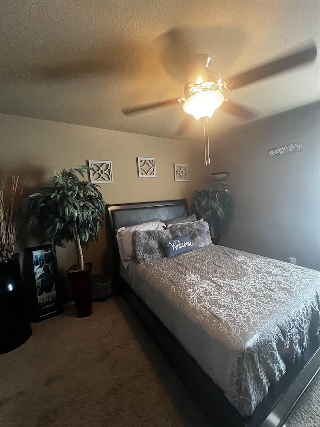 carpeted bedroom with a textured ceiling and ceiling fan