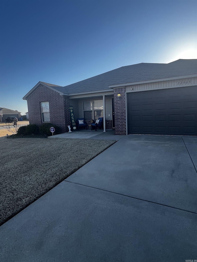 view of home's exterior featuring concrete driveway, an attached garage, and brick siding