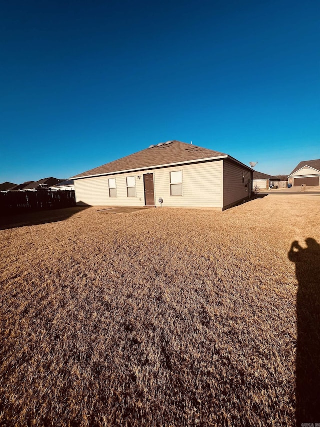 rear view of house featuring fence