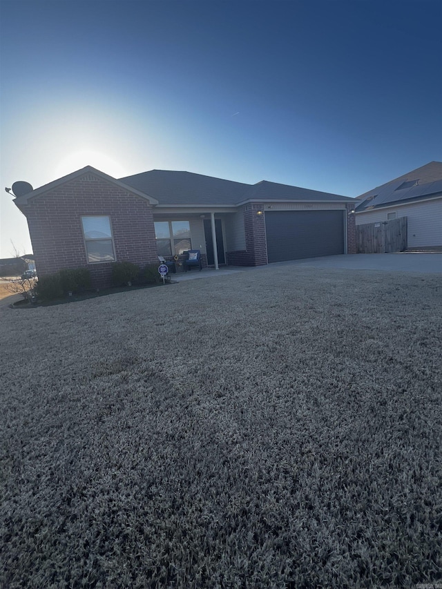 view of front of house featuring brick siding and a garage