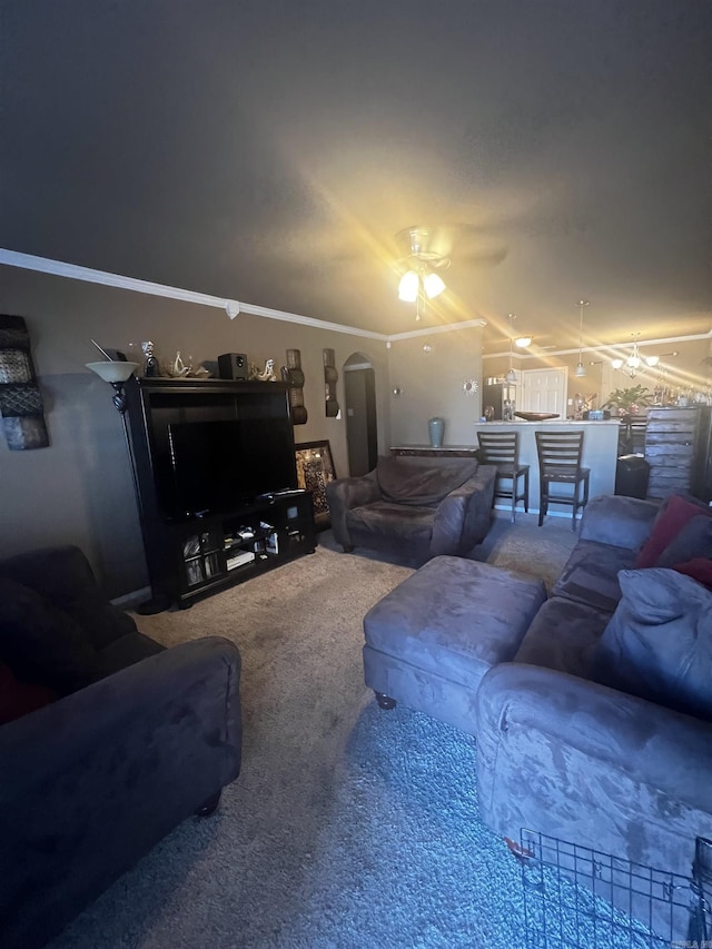 living area with arched walkways, carpet flooring, a ceiling fan, and vaulted ceiling