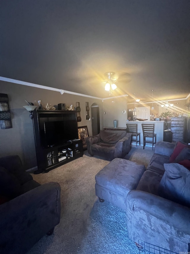 living area featuring arched walkways, crown molding, carpet flooring, and vaulted ceiling