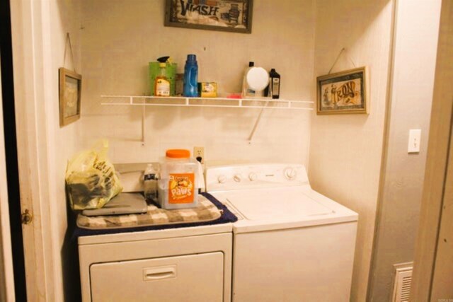 laundry room with laundry area and washing machine and clothes dryer