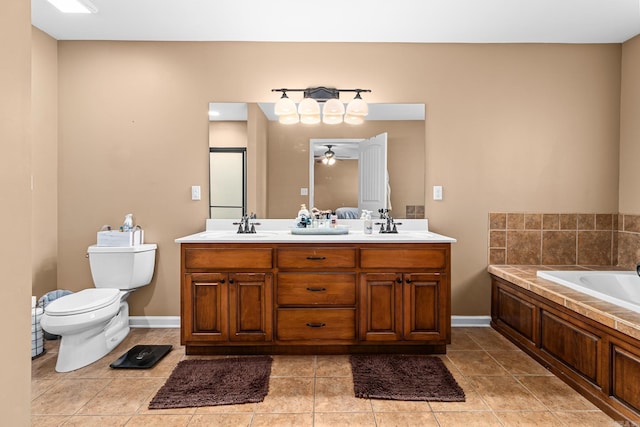 full bath featuring tile patterned floors, a garden tub, toilet, a sink, and double vanity