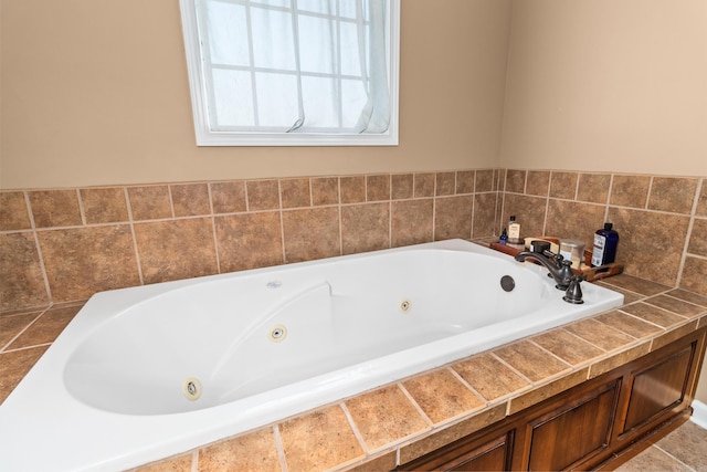 full bathroom with a tub with jets