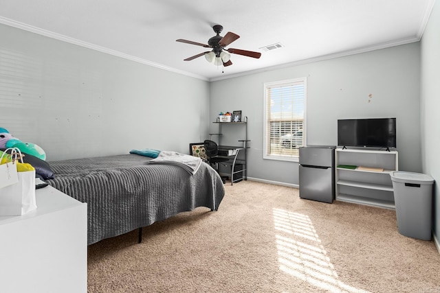 carpeted bedroom featuring visible vents, freestanding refrigerator, crown molding, baseboards, and ceiling fan