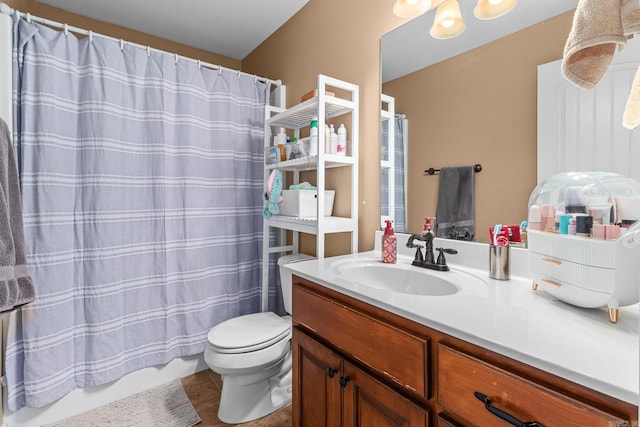 bathroom with tile patterned floors, a shower with shower curtain, toilet, and vanity