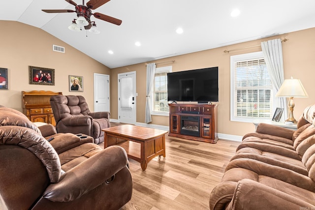 living room featuring visible vents, baseboards, light wood-type flooring, vaulted ceiling, and recessed lighting