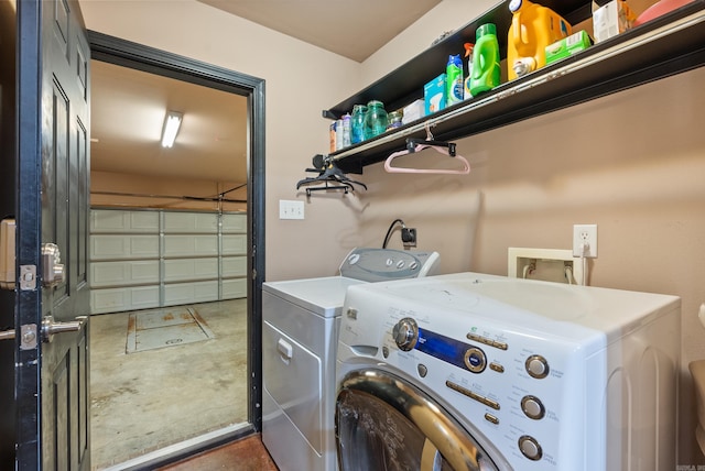 clothes washing area featuring laundry area, a garage, and separate washer and dryer