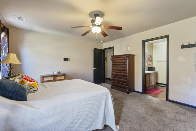 bedroom with visible vents, ensuite bathroom, carpet, baseboards, and ceiling fan